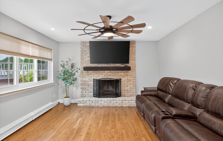 Fireplace, Interior, Living room, Recessed Lighting, Stone Walls, Wood Texture Flooring