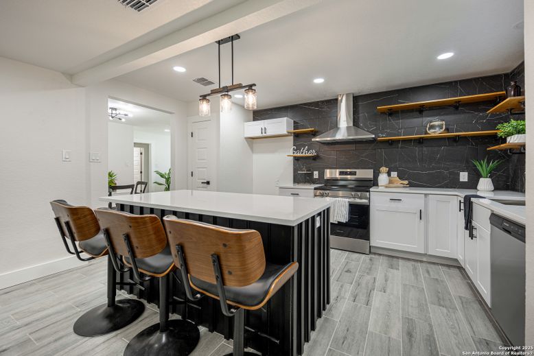 Interior, Kitchen, Marble Walls, Pendant Lights, Recessed Lighting, Stainless Steel Appliances, Wood Texture Flooring