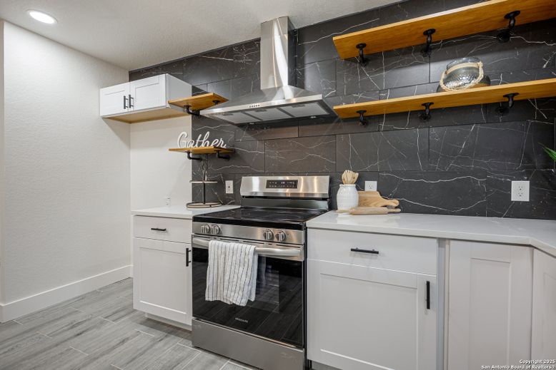 Interior, Kitchen, Marble Walls, Recessed Lighting, Stainless Steel Appliances, Wood Texture Flooring