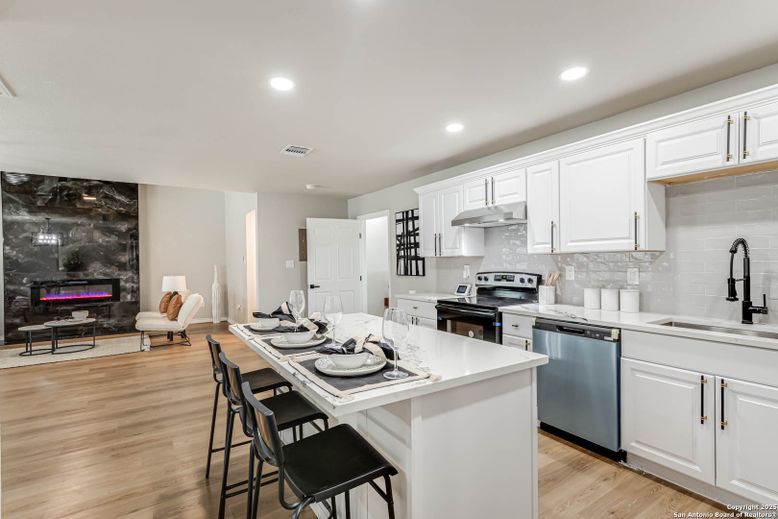 Fireplace, Interior, Kitchen, Recessed Lighting, Stainless Steel Appliances, Wood Texture Flooring