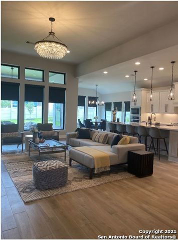 Chandelier, Dining room, Interior, Kitchen, Living room, Pendant Lights, Recessed Lighting, Stainless Steel Appliances, Wood Texture Flooring