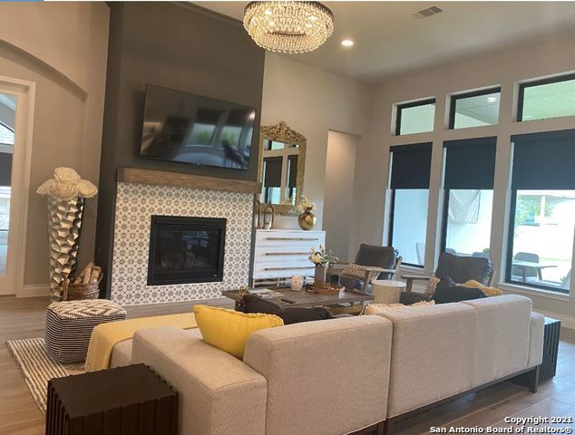Chandelier, Fireplace, Interior, Living room, Recessed Lighting, Wood Texture Flooring